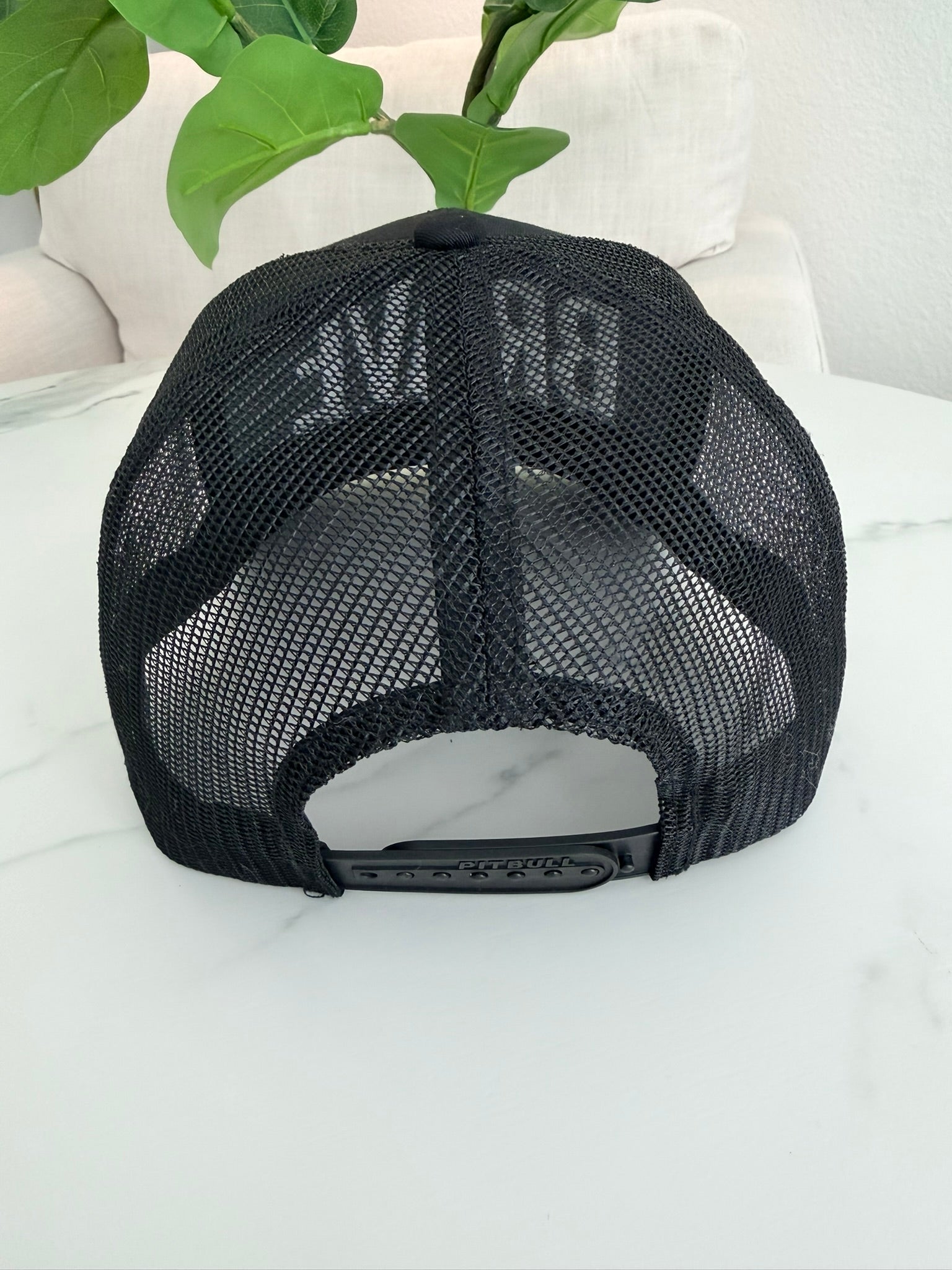 Black mesh cap with text on a black front
